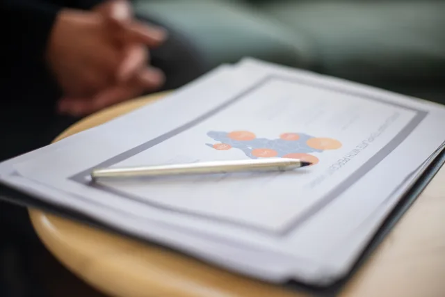 Close-up of business document and pen on a round table, perfect for office and corporate themes. Why the sales enablement market size in England is hard to pin down
