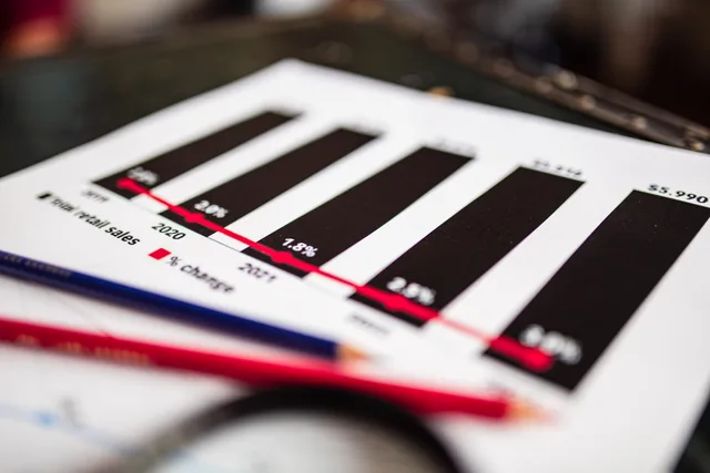 Close-up of a financial report showing sales data with dramatic depth of field. A guide to sales enablement salary benchmarks in Greater London and North West England
